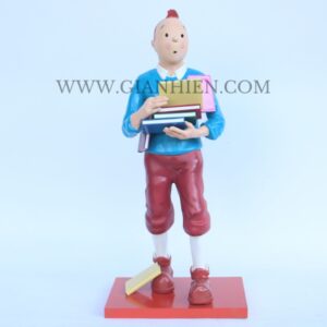 Tintin statue of boy holding book