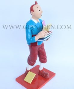 Tintin statue of boy holding book