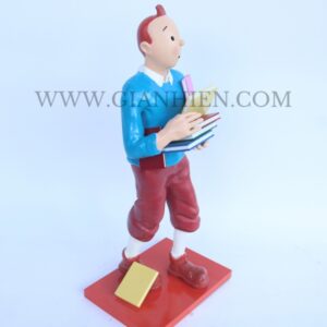 Tintin statue of boy holding book