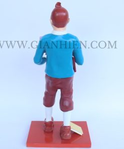 Tintin statue of boy holding book
