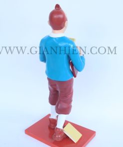 Tintin statue of boy holding book