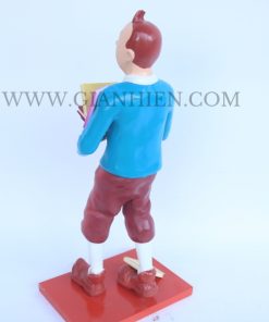 Tintin statue of boy holding book