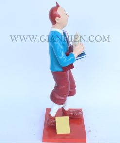 Tintin statue of boy holding book