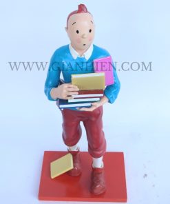 Tintin statue of boy holding book